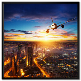 Plakat w ramie Samolot latający nad nowoczesnym miastem
