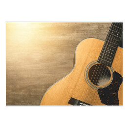 Plakat samoprzylepny Gitara akustyczna oświetlona światłem słonecznym na drewnianym tle 