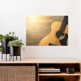 Plakat samoprzylepny Gitara akustyczna oświetlona światłem słonecznym na drewnianym tle 
