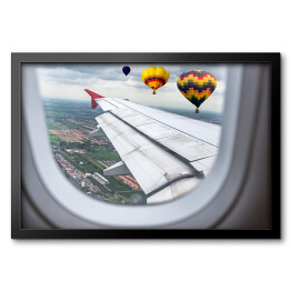 Obraz w ramie Widok za okno samolotu - balony unoszące się nad chmurami