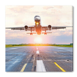 Obraz na płótnie Samolot startujący z lotniska o świcie