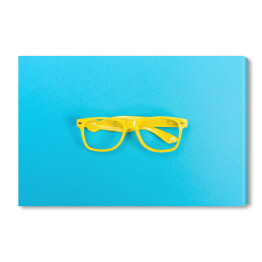 Obraz na płótnie Para żółtych okularów na jasnoniebieskim tle