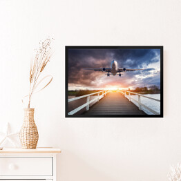 Obraz w ramie Samolot i drewniany most o zachodzie słońca