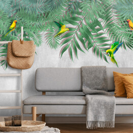 Fototapeta samoprzylepna Kolorowe papugi w wiszących liściach palmy na tle imitacji betonu
