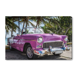 Obraz na płótnie Różowy retro samochód przy tropikalnej plaży